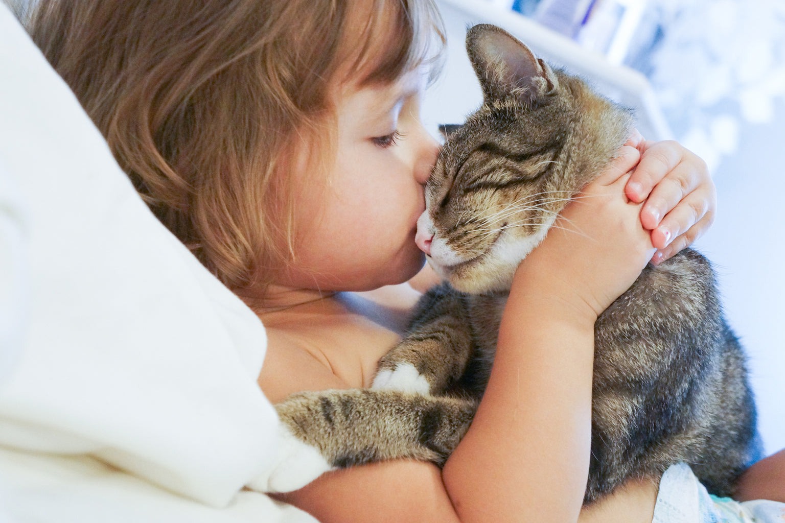 small girl kissing her pet car