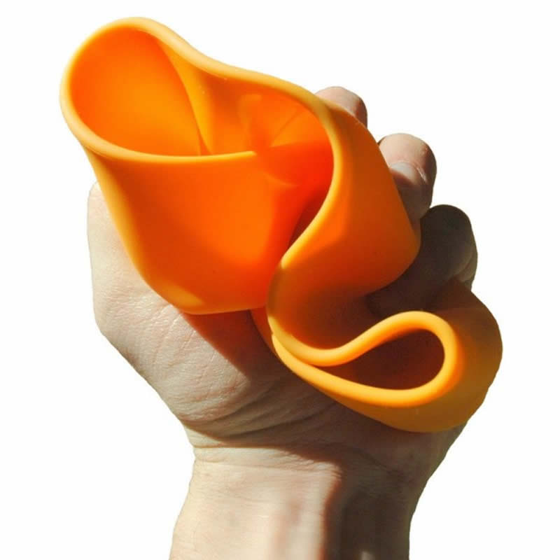 Hand holding an orange silicone pet travel bowl with a white background